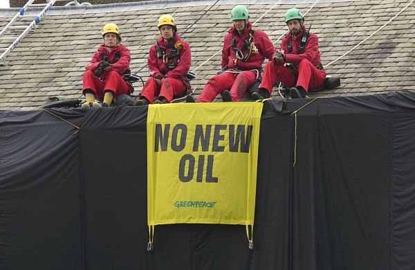 Greenpeace activists drape UK PM Rishi Sunak’s house in black to protest oil expansion-