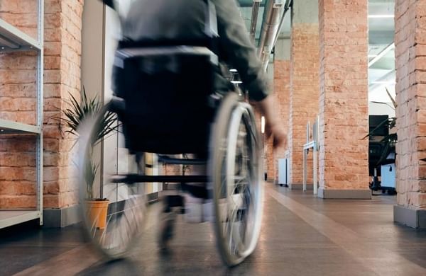 Wheel-chair bound bride carried up to marriage registrar’s second-floor office-